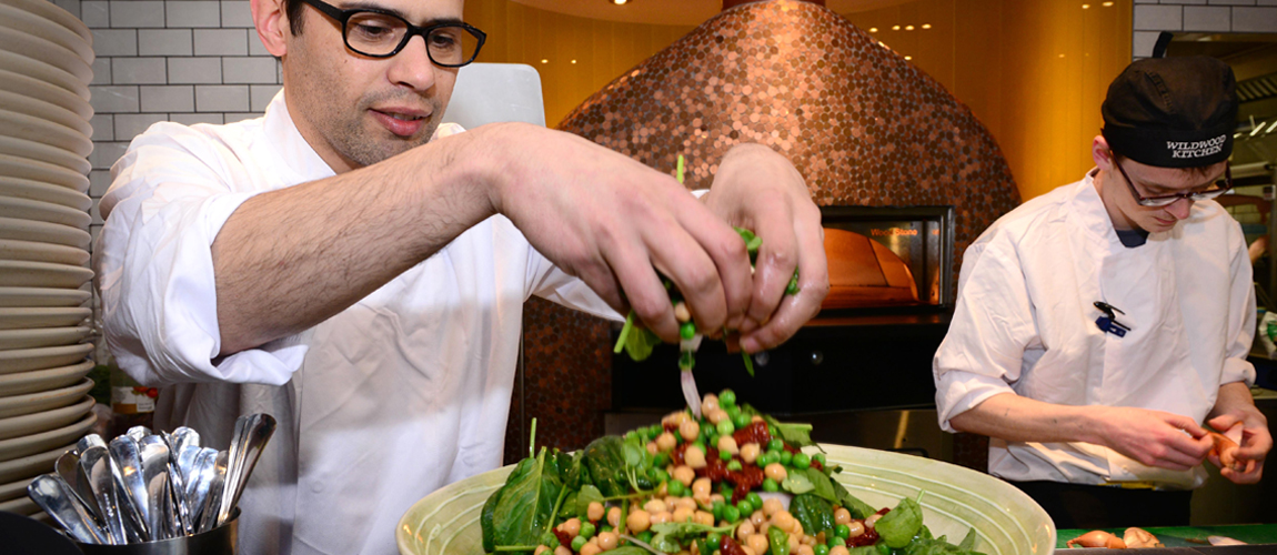 A photograph showing chefs preparring food