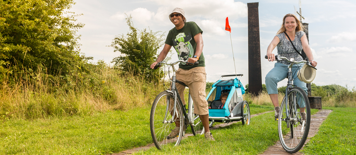 A photograph showing a family cycling in Telford Town Park